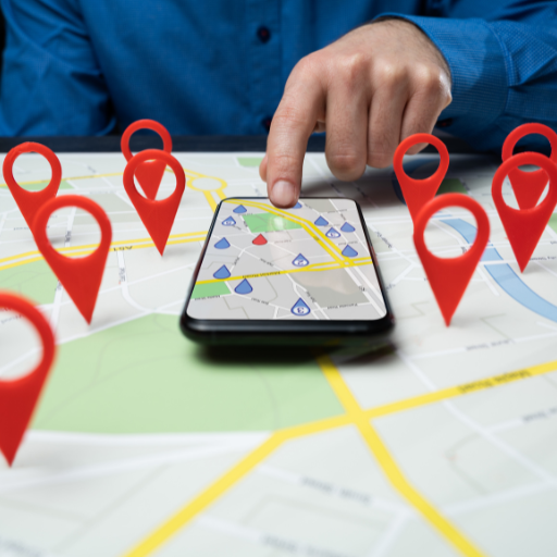 A person interacting with a map on a phone, with multiple red location pins, representing local business services